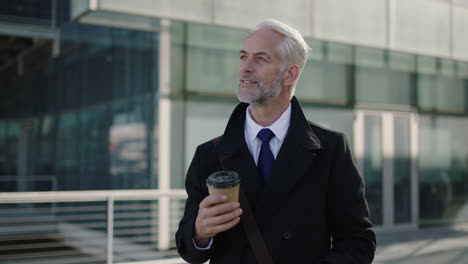 portrait-of-mature-ceo-businessman-looking-at-watch-impressed-holding-coffee