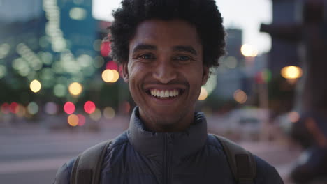 close-up-portrait-of-attractive-young-mixed-race-man-smiling-cheerful-at-camera-enjoying-calm-urban-evening-in-city-commuting-travel