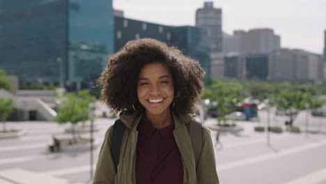 portrait-of-young-trendy-african-american-woman-student-with-afro-hairstyle-laughing-cheerful-enjoying-urban-lifestyle