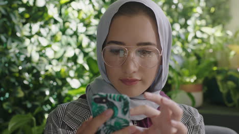 close-up-portrait-beautiful-muslim-business-woman-using-smartphone-texting-messaging-social-media-sharing-ideas-enjoying-mobile-phone-communication-wearing-hijab-headscarf-in-modern-office