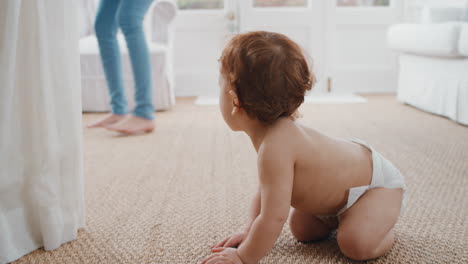 happy-baby-crawling-toddler-exploring-with-curiosity-at-home-with-mother-gently-picking-up-her-infant-helping-child-motherhood-responsibility-4k