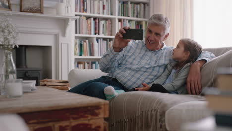 Großvater-Und-Kind-Unterhalten-Sich-Per-Video-Per-Smartphone.-Kleines-Mädchen-Teilt-Urlaubswochenende-Mit-Der-Familie.-Opa-Genießt-Es,-Zu-Hause-Mit-Seiner-Enkelin-über-Mobile-Technologie-Zu-Chatten