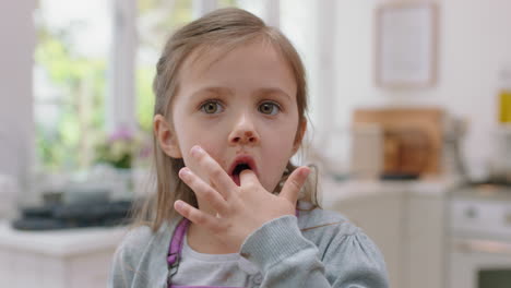 cute-little-girl-with-hands-covered-in-chocolate-licking-fingers-having-fun-baking-in-kitchen-naughty-child-enjoying-tasty-treat-at-home