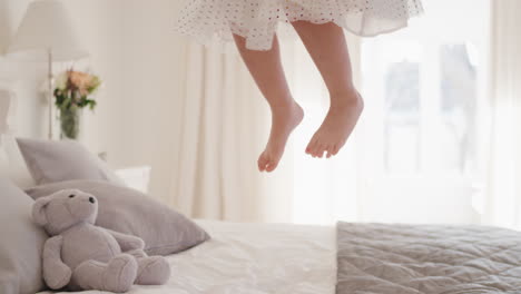 happy-little-girl-jumping-on-bed-having-fun-child-in-playful-mood-enjoying-weekend-morning-at-home-4k