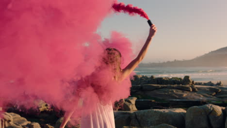 beautiful-woman-waving-pink-smoke-grenade-dancing-on-beach-at-sunrise-celebrating-creative-freedom-with-playful-dance-movement