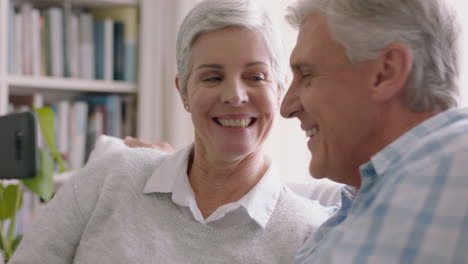 happy-old-couple-having-video-chat-using-smartphone-waving-at-grandchildren-enjoying-chatting-to-family-on-mobile-phone-sharing-lifestyle-relaxing-at-home-on-retirement-4k