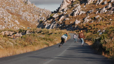 young-diverse-friends-longboarding-together-riding-skateboard-cruising-downhill-on-countryside-road-having-fun-enjoying-relaxed-summer-vacation