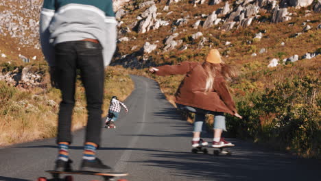 young-multi-ethnic-friends-longboarding-together-riding-skateboard-cruising-downhill-on-countryside-road-having-fun-enjoying-relaxed-summer-vacation