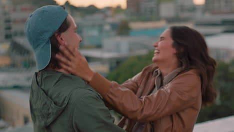 happy-caucasian-couple-hugging-on-rooftop-young-woman-excited-to-see-boyfriend-sharing-intimate-connection-hanging-out-enjoying-romantic-view-of-city-at-sunset