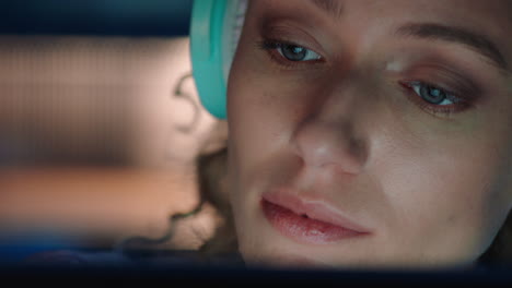 close-up-portrait-beautiful-woman-using-tablet-computer-browsing-online-enjoying-listening-to-music-wearing-headphones