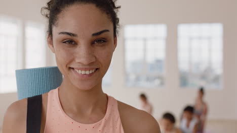 portrait-beautiful-mixed-race-yoga-woman-smiling-confidently-enjoying-healthy-lifestyle-with-people-practicing-in-fitness-studio-background