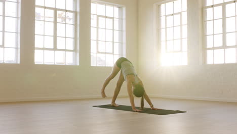 healthy-yoga-woman-practicing-three-legged-downward-facing-dog-pose-enjoying-fitness-lifestyle-exercising-in-workout-studio-stretching-training-on-exercise-mat-at-sunrise