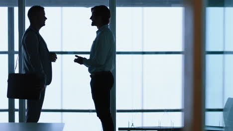 silhouette-business-people-shaking-hands-meeting-in-corporate-office-for-partnership-deal-greeting-client-with-handshake-welcoming-opportunity-in-office-4k