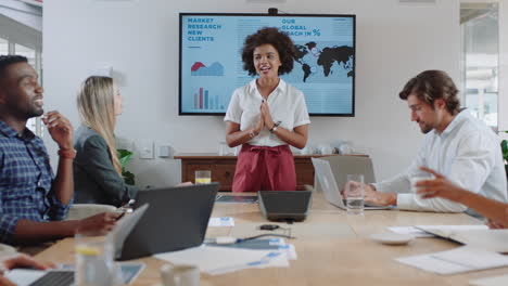 business-people-meeting-in-boardroom-mixed-race-team-leader-woman-presenting-financial-strategy-with-graph-data-on-tv-screen-briefing-colleagues-discussing-ideas-in-office-presentation