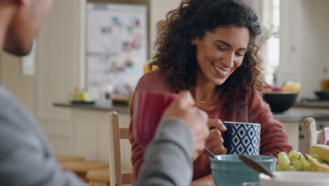 beautiful-happy-woman-drinking-coffee-chatting-to-husband-at-home-enjoying-conversation-in-kitchen-at-breakfast