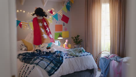 happy-little-girl-jumping-on-bed-wearing-costume-playing-game-enjoying-playful-imagination-in-colorful-bedroom-at-home