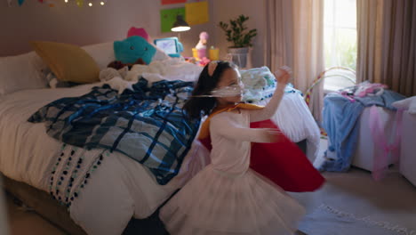 happy-little-girl-dancing-wearing-costume-playing-game-enjoying-playful-imagination-in-colorful-bedroom-at-home
