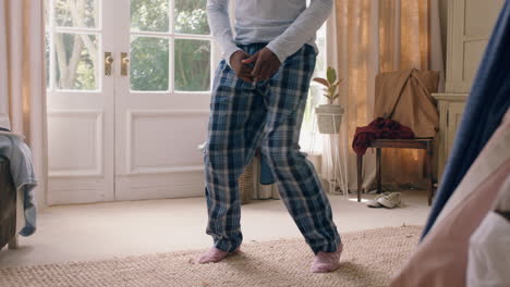funny-african-american-man-dancing-in-bedroom-having-fun-celebrating-feeling-positive-enjoying-successful-lifestyle-doing-silly-dance-at-home-on-weekend-morning-wearing-pajamas