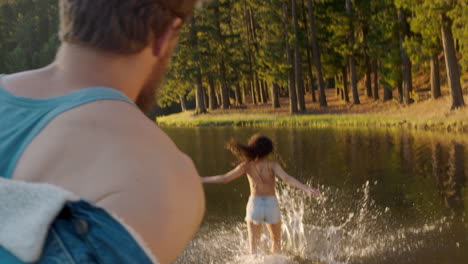 happy-couple-splashing-in-lake-at-sunset-having-fun-playing-in-water-enjoying-summer-love
