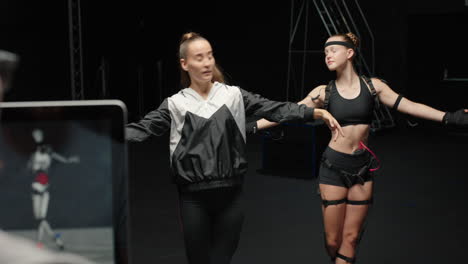 dancing-woman-wearing-motion-capture-suit-rehearsing-ballet-dance-with-instructor-girl-wearing-mo-cap-suit-for-3d-character-animation-for-virtual-reality-technology