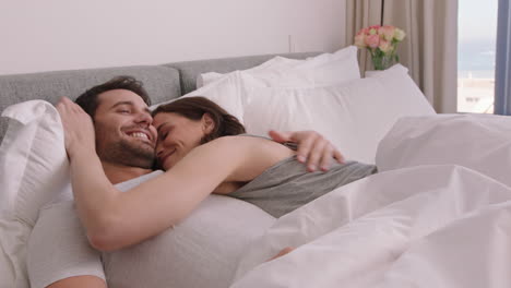 happy-young-couple-lying-in-bed-embracing-sharing-romantic-relationship-enjoying-intimacy-together-at-home