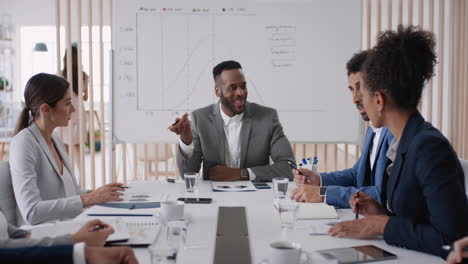 african-american-businessman-team-leader-meeting-with-colleagues-sharing-creative-ideas-for-startup-project-discussing-corporate-strategy-in-office-boardroom