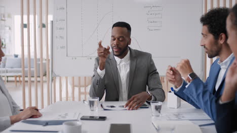 african-american-businessman-team-leader-meeting-with-colleagues-sharing-creative-ideas-for-startup-project-discussing-corporate-strategy-in-office-boardroom
