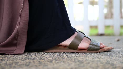 Side-view-of-f-girls-feet-wearing-sandal-outdoor