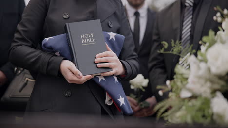 Hands,-american-flag-and-bible-with-a-person