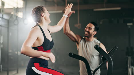 Woman,-cycling-and-personal-trainer-in-high-five