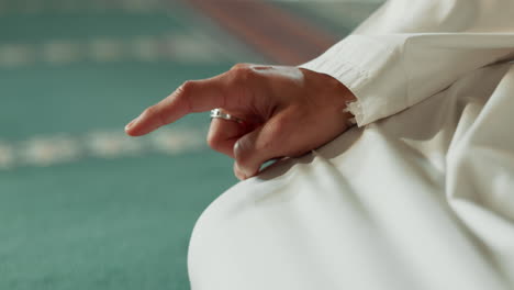 Islam,-floor-and-closeup-of-a-pointing-finger