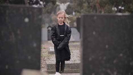 Sad,-death-or-kid-in-cemetery-for-funeral