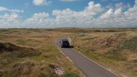 Tracking-of-car-driving-on-narrow-path-in-flat-countryside.-Approaching-to-oncoming-cyclists.-Denmark