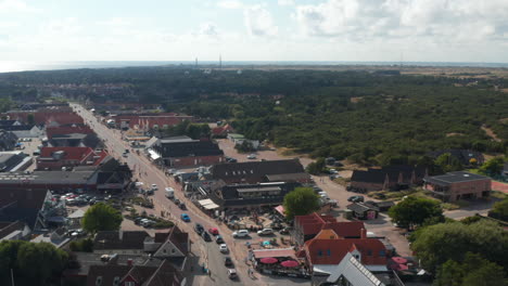 Aerial-panoramic-footage-of-small-town.-Large-buildings-with-shops-and-restaurants-along-wide-road-in-town-centre.-Denmark