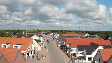 Aerial-footage-of-shopping-street-in-Oksby.-Fly-above-people-strolling-in-centre-of-small-coastal-town.-Summer-vacation-destination.-Denmark