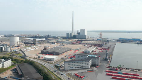 Slow-rotation-birds-eye-over-the-Esbjerg-harbor-and-the-Steelcon-chimney-of-the-coal-fired-power-station.-This-chimney-is-the-tallest-in-all-Scandinavia