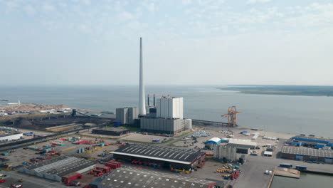 Panning-aerial-view-over-the-power-plant-of-Esbjerg,-Denmark.-The-Steelcon-power-station-chimney-is-the-tallest-in-Scandinavia