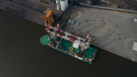 Aerial-view-of-Liebherr-Seafox-5-offshore-crane-moored-in-front-of-Esbjerg's-Power-Station-in-Denmark.-With-a-maximum-lifting-capacity-of-1,200t-is-the-biggest-crane-of-the-board-offshore-crane-series