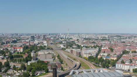 Transport-infrastructure-in-town.-Aerial-view-on-cityscape-with-railway-track.-Fernsehturm-TV-tower-in-distance.-Berlin,-Germany