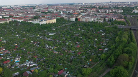 Aerial-panoramic-view-of-urban-neighbourhood-with-allotment-gardens.-Greenery-in-town.-Berlin,-Germany