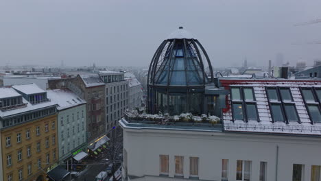 Rising-footage-of-design-steel-construction-around-glass-cupola-on-top-of-building.-City-in-winter.-Berlin,-Germany