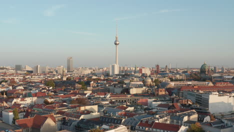 Sunny-afternoon-panoramic-aerial-view-of-city-with-TV-lookout-tower-landmark.-Slow-movement-forwards.-Berlin,-Germany.