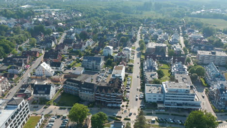 Aerial-view-of-residential-area-by-Baltic-sea-coastline-tourist-beach-in-Scharbeutz,-Germany,-circle-pan,-day