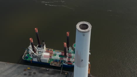 Aerial-view-of-the-chimney-of-Esbjerg-Power-Station-in-Denmark.-Drone-view-revealing-Liebherr-Seafox-5,-the-biggest-offshore-crane-moored-at-harbour