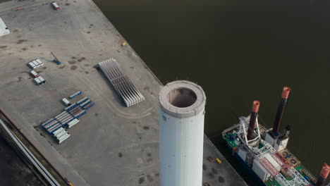 Aerial-flight-slowly-rotation-around-the-chimney-of-Esbjerg-Power-Station-in-Denmark.-The-power-plant-will-not-longer-use-coal-as-fuel-by-2023-and-the-chimney-is-the-tallest-in-Scandinavia
