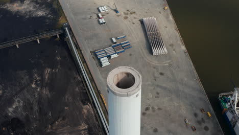 Aerial-flight-slowly-rotation-around-the-chimney-of-the-power-station-in-Esbjerg,-Denmark,-a-power-plant-with-goal-of-net-zero-emissions-by-the-year-2025-and-no-carbon-emissions-by-2040