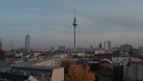 Forwards-reveal-of-20th-century-architecture-in-centre-of-town-with-dominant-tall-TV-tower,-Fernsehturm.-Berlin,-Germany.