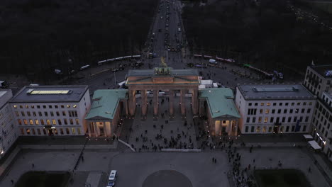 High-angle-shot-of-Brandenburger-Tor-in-evening.-Protest-of-farmers,-tractors-blocking-road-in-capital-city.-Berlin,-Germany