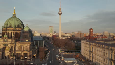 AERIAL:-Low-over-Berlin-Central,-Mitte-with-view-on-Alexanderplatz-TV-Tower-and-Cathedral-on-beautiful-sunny-day