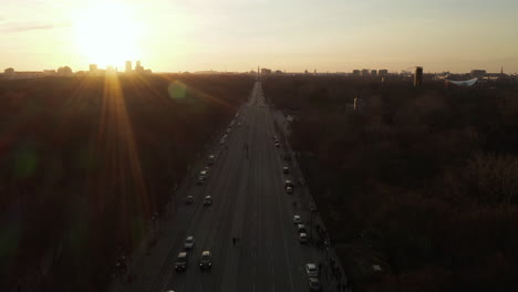 AERIAL:-Over-17th-of-June-Street-and-Tiergarten-towards-Berlin-Victory-Column-in-beautiful-Sunset-light